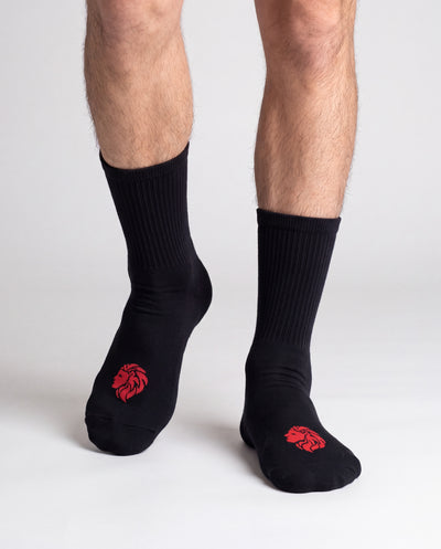 HercSocks Crew Socks in black, worn on feet, front view